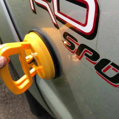 guy uses Cumuul Car Dent Puller to pull surface